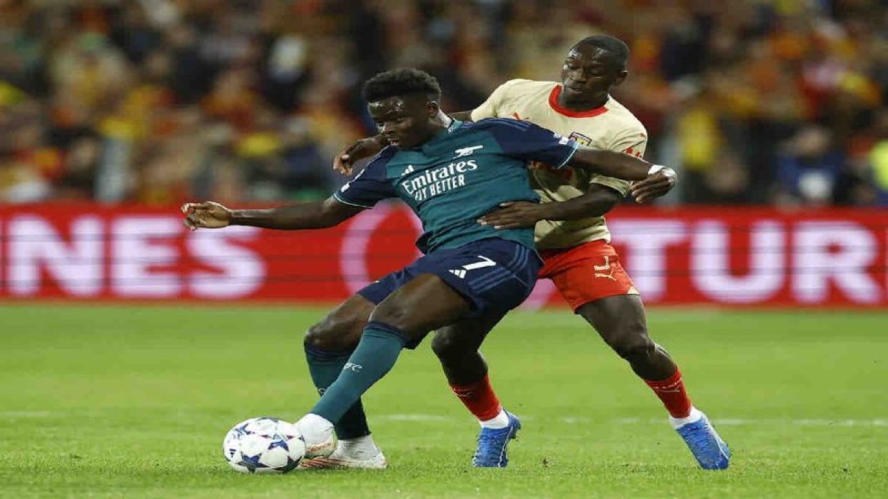 Pemain Arsenal Bukayo Saka berebut bola dengan Deiver Machado dari RC Lens dalam pertandingan Liga Champions Grup B di Stade Bollaert-Delelis, Lens, Selasa (3/102023). ANTARA/REUTERS/Christian Hartmann