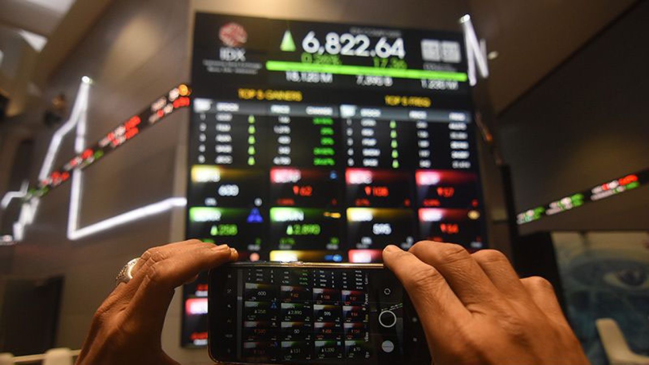 Pegawai memotret layar pergerakan saham di Bursa Efek Indonesia, Jakarta, Senin (3/4/2023). ANTARA FOTO/Indrianto Eko Suwarso/tom/aa.