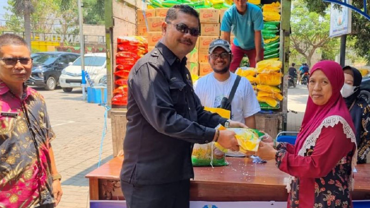 Kepala Diskoperindag Kabupaten Situbondo, Jawa Timur, Edy Wiyono secara simbolis menyerahkan beras SPHP kepada warga dalam operasi pasar di Kecamatan Banyuglugur. Kamis (12/10/2023) ANTARA/Novi Husdinariyanto