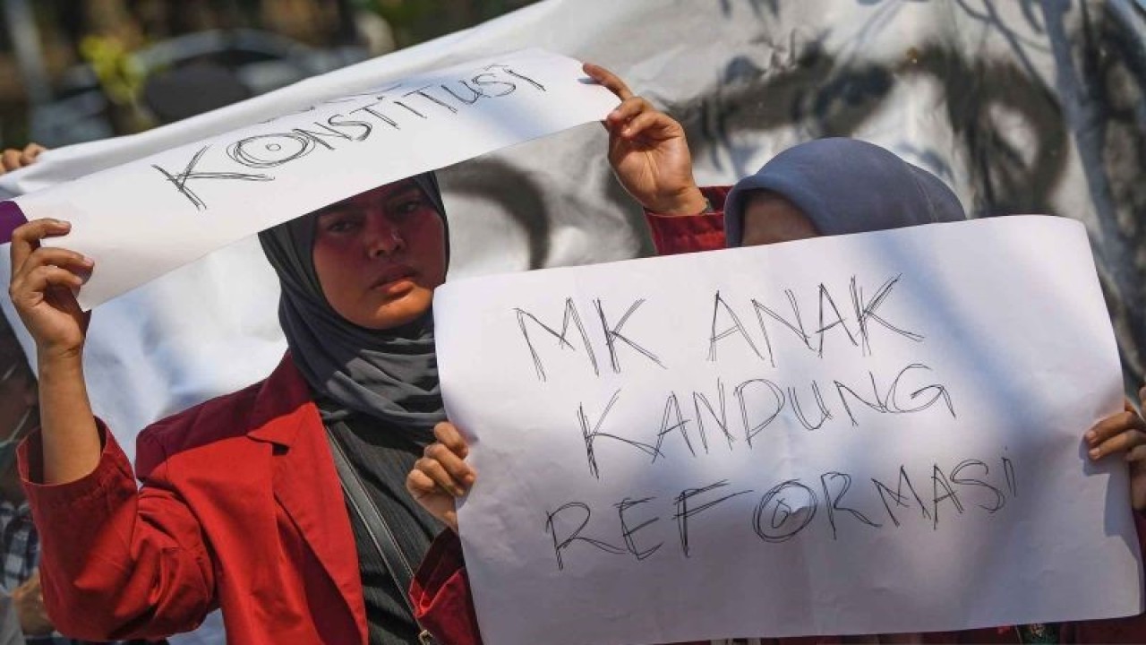 Pengunjuk rasa membawa poster berisi pesan tuntutan dalam aksi di depan Gedung Mahkamah Konstitusi (MK), Jakarta, Minggu (15/10/2023). (ANTARA FOTO/Aditya Pradana Putra/nym)