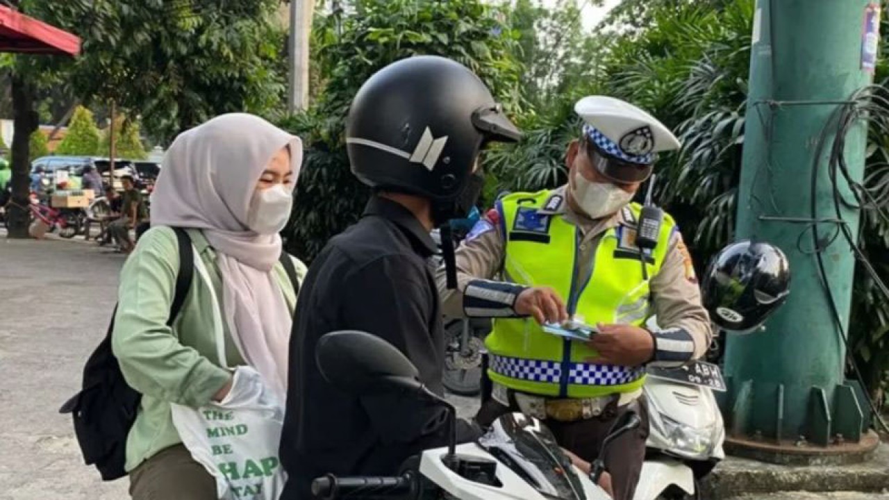 Personel Satuan Lalu Lintas Polres Metro Jakarta Selatan menilang pengendara yang melanggar aturan berlalu lintas di kawasan Prapanca Raya, Jakarta, Selasa (11/7/2023). ANTARA/Luthfia Miranda Putri