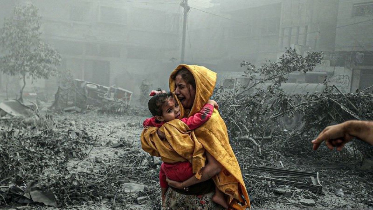 Seorang wanita menggendong seorang gadis bereaksi setelah serangan udara Israel menghantam lingkungan Ridwan di Kota Gaza, Gaza pada 23 Oktober 2023. (ANTARA/Ali Jadallah / Anadolu/pri.)