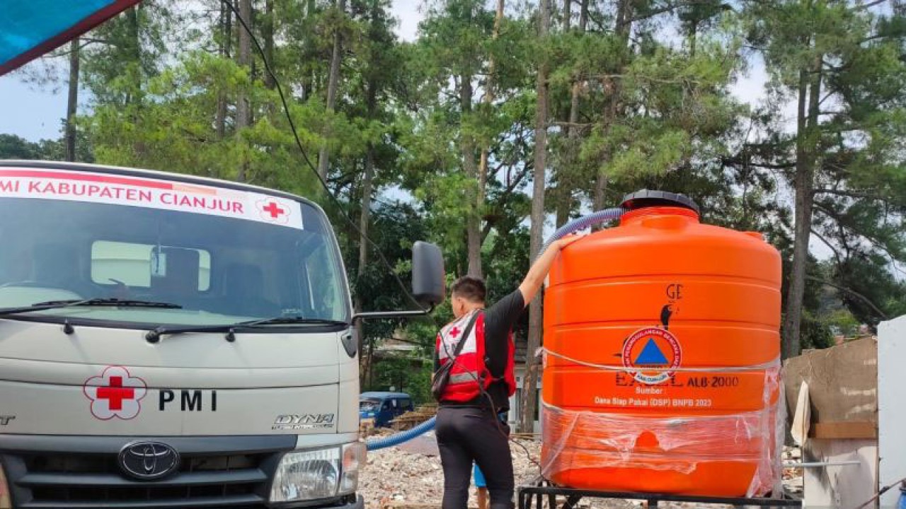 Relawan Palang Merah Indonesia (PMI) Kabupaten Cianjur, Jawa Barat, masih memberikan pelayanan air bersih untuk warga di Kecamatan Cugenang yang masih kesulitan mendapatkaan air bersih, Senin (13/11/2023).(ANTARA/Ahmad Fikri)
