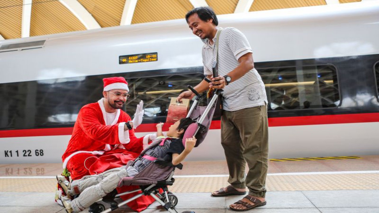 Arsip - Seorang pekerja mengenakan kostum Sinterklas berbagi hadiah kepada penumpang di Stasiun Kereta Cepat Halim, Jakarta, Minggu (24/12/2023). . ANTARA FOTO/Asprilla Dwi Adha/tom (ANTARA FOTO/ASPRILLA DWI ADHA)