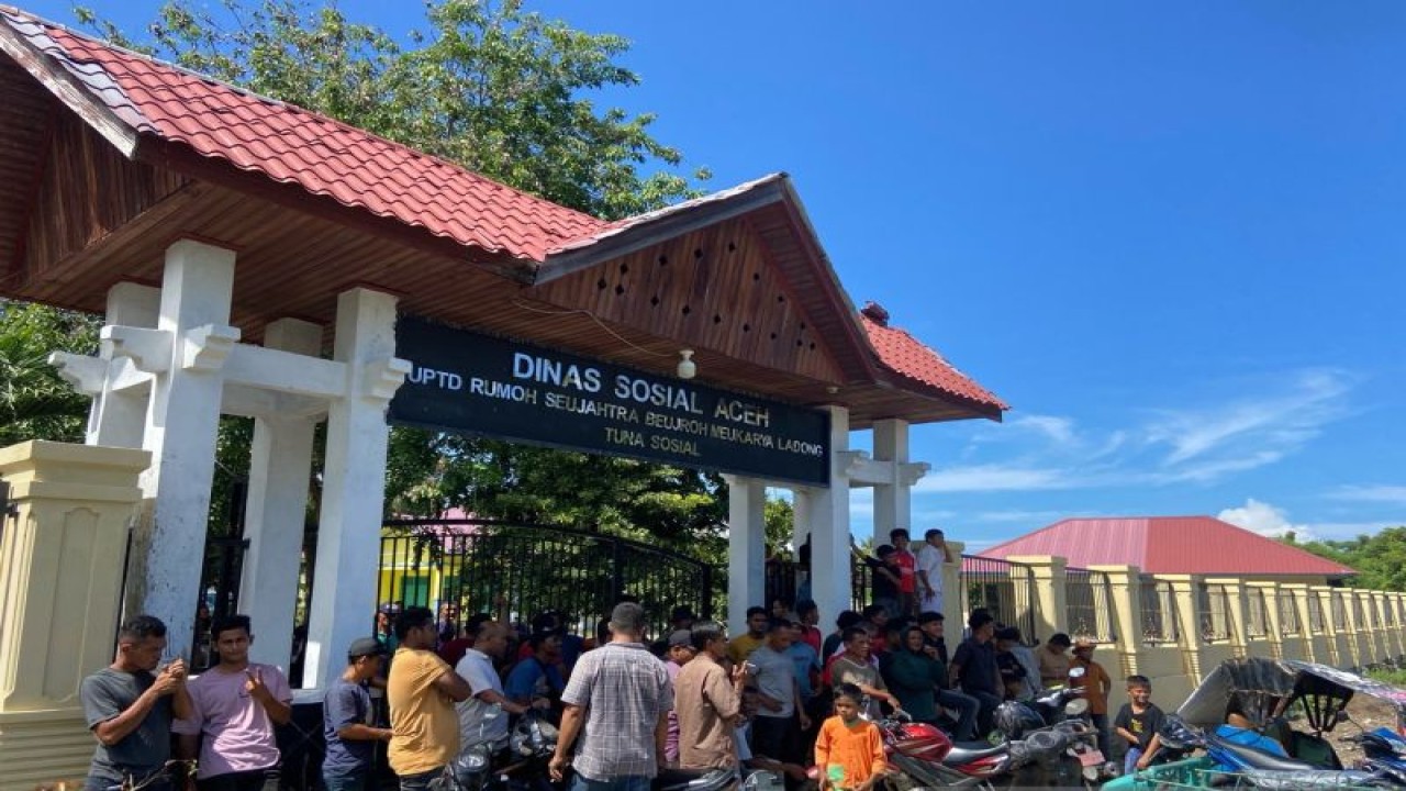 Warga Ladong berdiri di depan gerbang UPTD Rumoh Seujahtera Beujroh Meukarya Ladong Tuna Sosial di Gampong Ladong, Aceh Besar untuk menolak penempatan rohingya, di Aceh Besar, Senin (11/12/2023). (ANTARA/Khalis Surry)