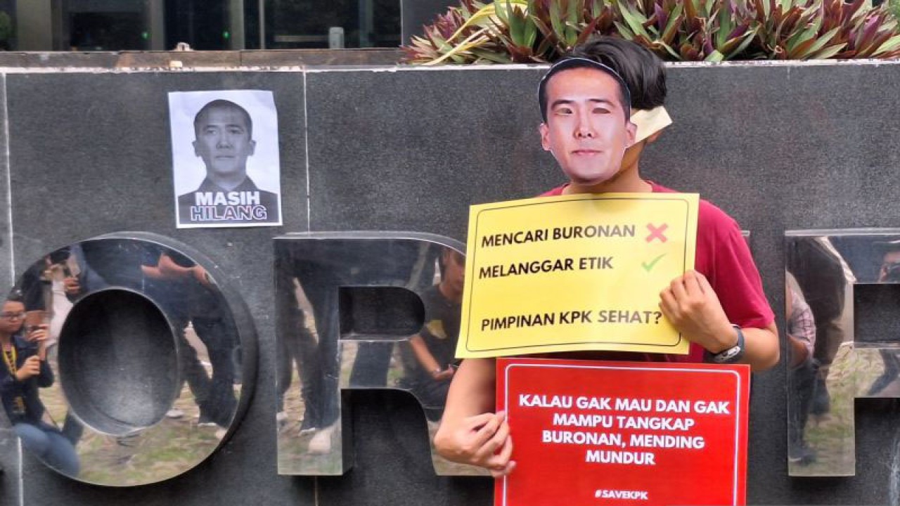 Pegiat antikorupsi mengenakan topeng Harun Masiku dalam unjuk rasa di Gedung Merah Putih KPK, Jakarta Selatan, Senin (15/1/2024). ANTARA/Fianda Sjofjan Rassat