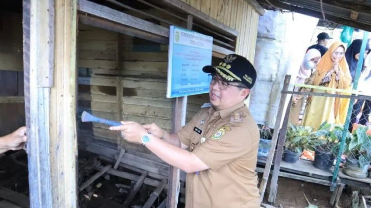 Wali Kota Banjarmasin H Ibnu Sina saat melakukan pembongkaran secara simbolis perbaikan rumah warga tidak layak huni pada 2023. (ANTARA/Sukarli)