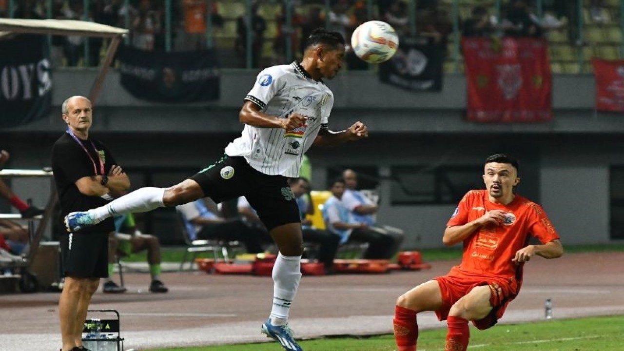 Foto arsip - Pesepak bola PSS Sleman A Lestaluhu (tengah) menyundul bola dengan penjagaan pesepak bola Persija Jakarta Olivier Bias (kanan) pada pertandingan Liga 1 di Stadion Patriot Chandrabhaga, Bekasi, Jawa Barat, Sabtu (16/12/2023). Skor 1-0 untuk kemenangan Persija Jakarta. ANTARA FOTO/ Fakhri Hermansyah/rwa.