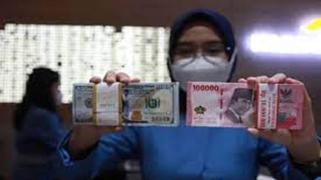 Petugas menunjukkan uang dolar AS dan uang rupiah di salah satu kantor cabang PT. Bank Mandiri Persero Tbk, Jakarta, Selasa (31/1/2023). ANTARA FOTO/Reno Esnir/tom.