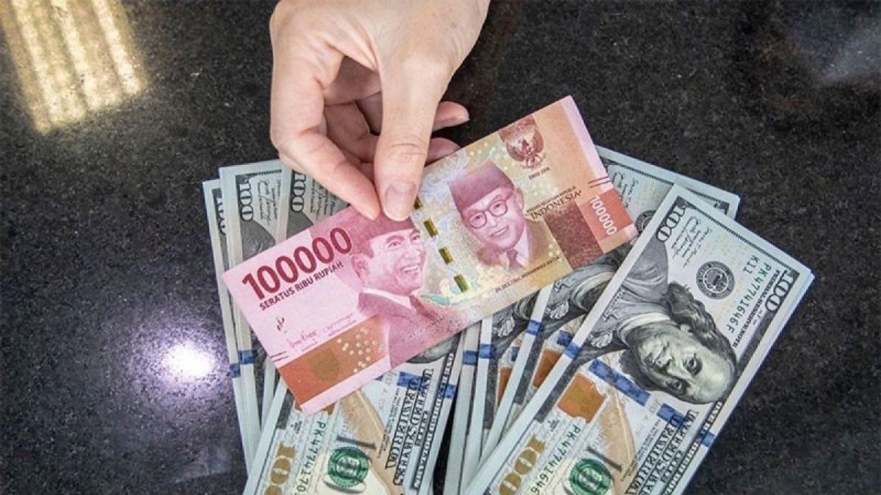Petugas menunjukan uang pecahan rupiah dan dolar AS di gerai penukaran mata uang asing VIP (Valuta Inti Prima) Money Changer, Jakarta, Selasa (4/10/2022). ANTARA FOTO/Muhammad Adimaja/aww.