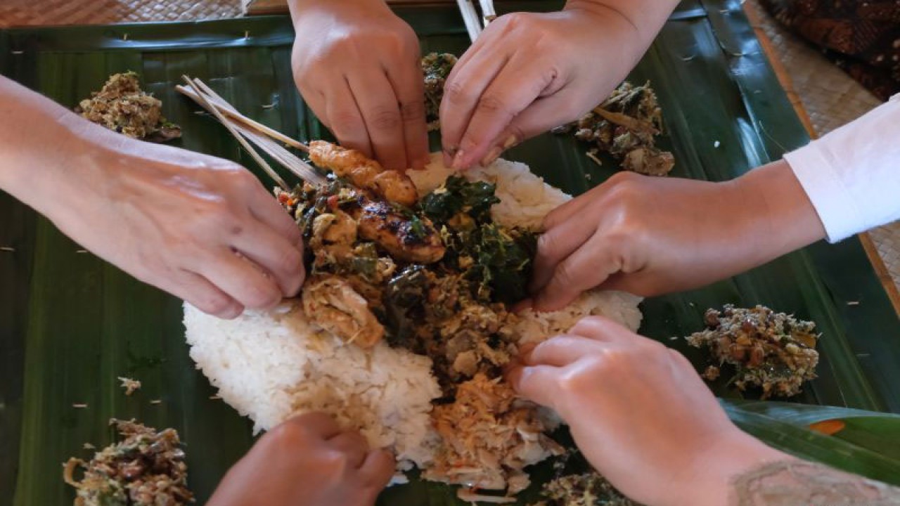 Arsip foto - Peserta mengikuti tradisi Megibung atau makan bersama khas Bali saat perjalanan kuliner Qatar-Indonesia 2023 Year of Culture di Taman Soekasada Ujung, Karangasem, Bali, Rabu (28/6/2023). (ANTARA FOTO/Nyoman Hendra Wibowo/foc)