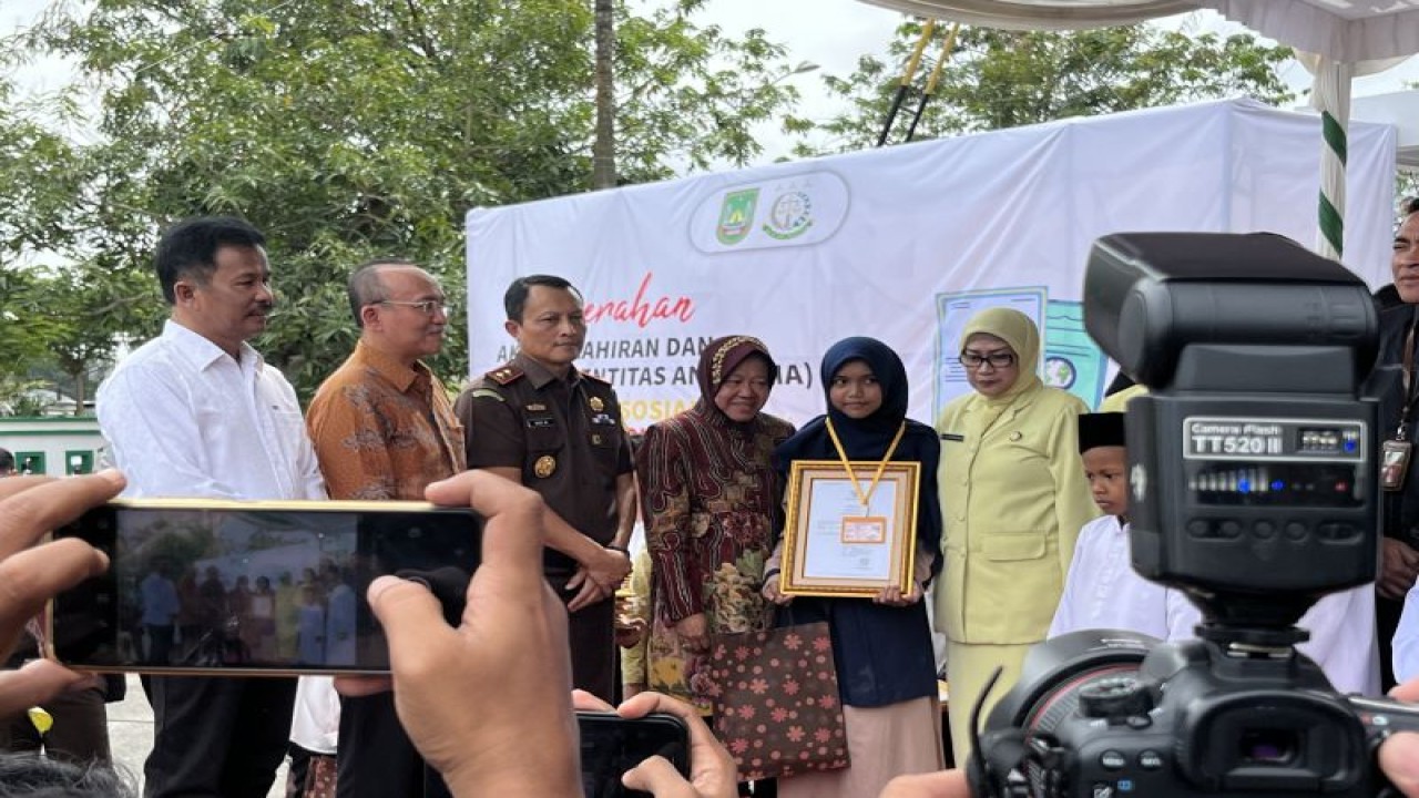 Menteri Sosial Tri Rismaharini secara simbolis menyerahkan dokumen kependudukan anak di Kota Batam, Provinsi Kepulauan Riau, Rabu (24/1/2024). (ANTARA/Jessica)