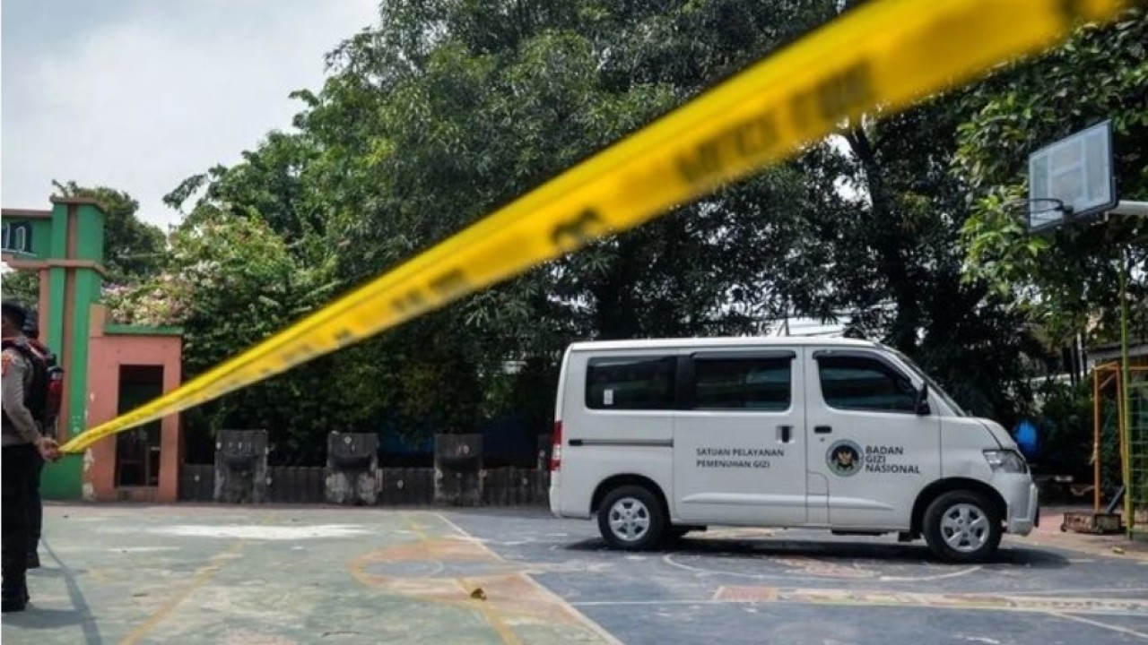 Polisi berjaga di dekat mobil pengangkut Makan Bergizi Gratis (MBG) yang menabrak siswa dan guru di SDN Kalibaru 01 Pagi, Cilincing, Jakarta, Kamis, 11 Desember 2025. Kejadian tersebut mengakibatkan sebanyak 21 orang yang merupakan siswa dan guru sek (Antara)